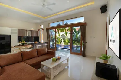 a living room with a couch and a table at Holl Villa by Wildflower Group in Legian