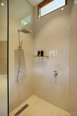 a shower with a glass door in a bathroom at Holl Villa by Wildflower Group in Legian