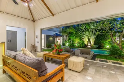 a living room with a couch and a table at Villa Irma in Seminyak