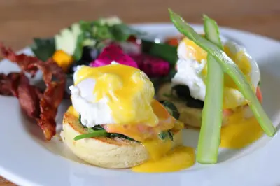 a plate of food with an egg sandwich and a salad at Villa Jerami & Spa in Seminyak