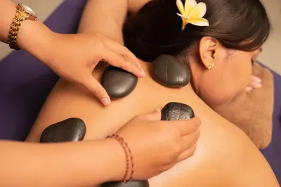 a woman having her stomach examined by a therapist at Villa Jerami & Spa in Seminyak