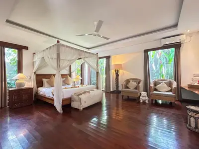 a bedroom with a bed with a canopy at Villa Anema Umalas in Seminyak