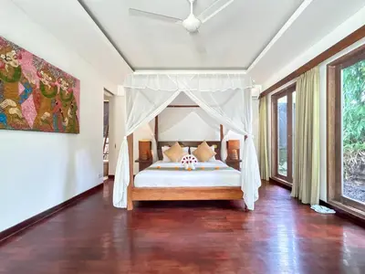 a bedroom with a bed with a canopy at Villa Anema Umalas in Seminyak