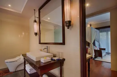 a bathroom with a sink and a mirror at Natya Villa Jimbaran in Jimbaran
