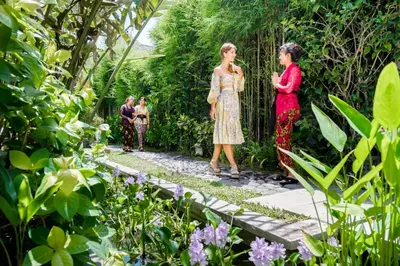 two women are standing in a garden at Mayaloka Villas Seminyak in Seminyak