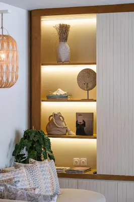 a yellow shelf with vases and a plant on it at Akara Villa in Seminyak
