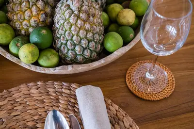 a table with two baskets of fruit and a wine glass at Akara Villa in Seminyak