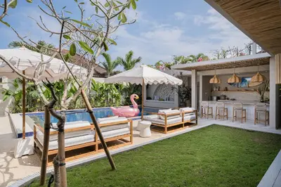 a swimming pool with a pink flamingo in a backyard at Akara Villa in Seminyak