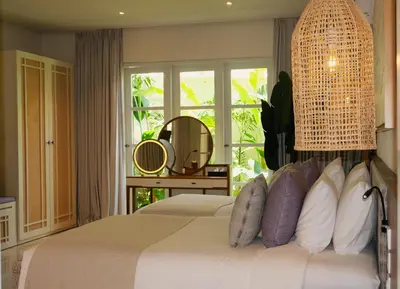 a bedroom with a bed with a large window at Akara Villa in Seminyak