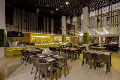 a restaurant with tables and chairs and a bar at THE HAVEN Bali Seminyak in Seminyak