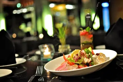 a white plate of food on a table at THE HAVEN Bali Seminyak in Seminyak