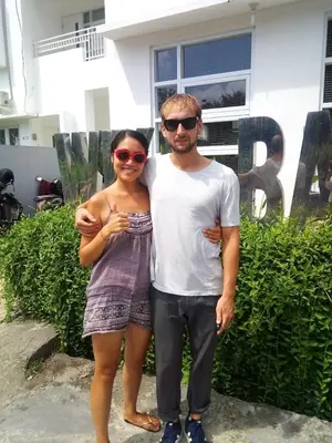 a man and a woman standing in front of a house at Wika Bali Beach House in Jimbaran
