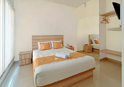 a bedroom with a bed with a towel on it at Wika Bali Beach House in Jimbaran