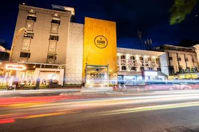 a city street at night with buildings and cars at Stark Boutique Hotel and Spa in Kuta