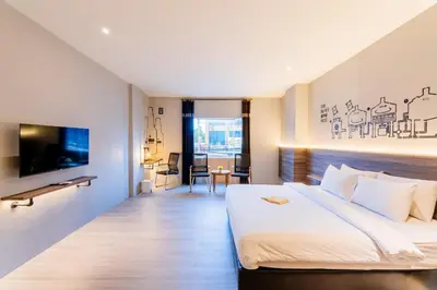 a hotel room with a bed and a tv at Stark Boutique Hotel and Spa in Kuta