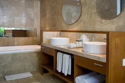 a bathroom with two sinks and a tub at The Amala Boutique Retreat in Seminyak