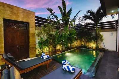 a swimming pool in the middle of a house at Villa Raka Managed by Manara in Legian