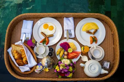 a picnic basket with eggs and breakfast foods at Villa Raka Managed by Manara in Legian