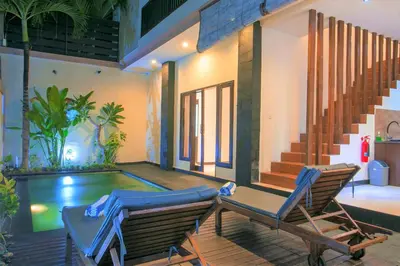 a patio with two chairs and a swimming pool at Villa Raka Managed by Manara in Legian