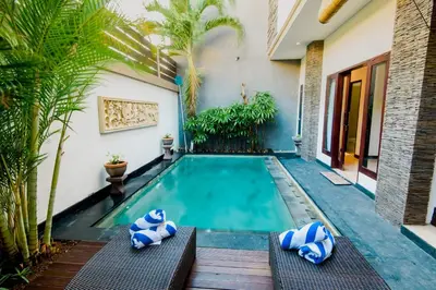 a swimming pool in the backyard of a house at Villa Raka Managed by Manara in Legian