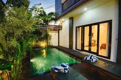 a swimming pool in the middle of a house at Villa Raka Managed by Manara in Legian