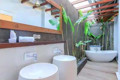 a bathroom with a sink and a toilet and a tub at Villa La Luvier in Canggu