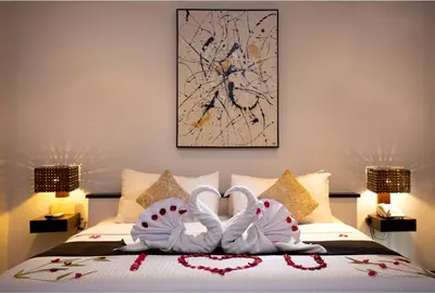 two swansrendered to look like hearts are sitting on a bed at Danoya Private Luxury Residences in Seminyak
