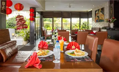 a table with two plates of food on it in a restaurant at Danoya Private Luxury Residences in Seminyak