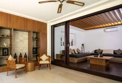 a living room with a bed and a table at Danoya Private Luxury Residences in Seminyak