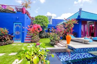 a blue house with a pool in the yard at Villa Majorelle Bali in Seminyak