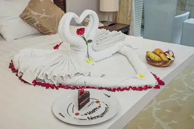 a cake with two swans on top of a table at Dekuta in Kuta