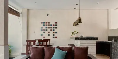 a living room with a couch and a table at Aruni Bali Jimbaran Boutique Villa in Jimbaran