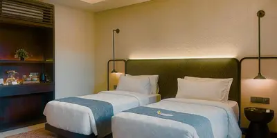 a hotel room with two beds in a room at Aruni Bali Jimbaran Boutique Villa in Jimbaran