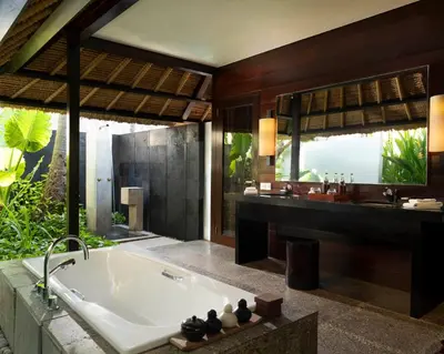 a bathroom with a large tub and a sink at Kayumanis Jimbaran Private Villas & Spa in Jimbaran