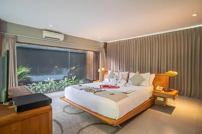 a bedroom with a bed and a large window at Ziva a Boutique Villa in Seminyak