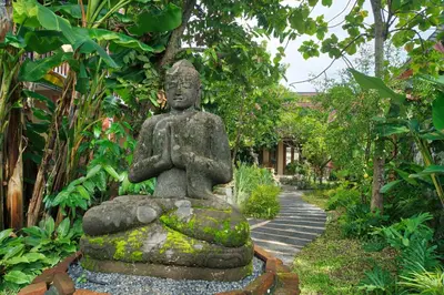 a statue in the middle of a garden at The Garden Villa in Sanur