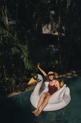 a woman sitting on a rubber duck in the water at Le Jardin Villas Seminyak in Seminyak