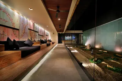 a long hallway with couches and plants in a building at The Seiryu Boutique Bali Villas in Seminyak