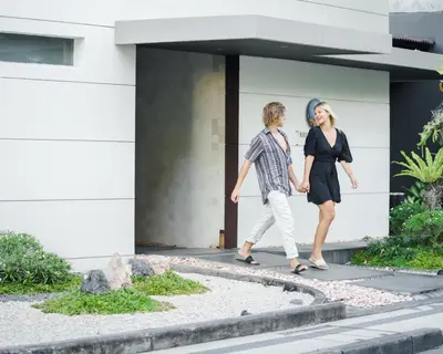 a man and a woman walking outside of a building at The Seiryu Boutique Bali Villas in Seminyak