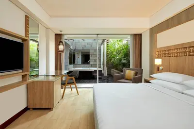 a hotel room with a bed and a television at Fairfield by Marriott Bali Legian in Legian