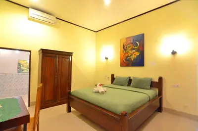 a bedroom with a bed with a stuffed animal on it at Arik Homestay Canggu in Canggu