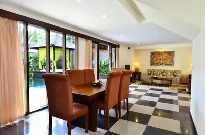 a dining room with a table and chairs at The Khayangan Dreams Villa, Seminyak in Seminyak