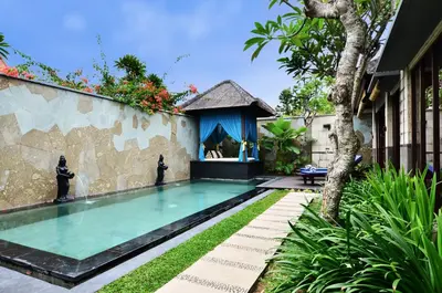 a swimming pool with a gazebo next to a house at The Khayangan Dreams Villa, Seminyak in Seminyak