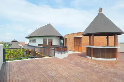 a large deck with a gazebo on a house at djabu Seminyak Hotel in Seminyak