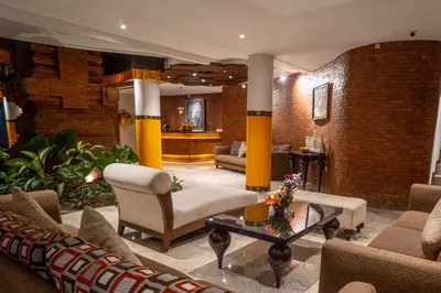 a lobby with couches and chairs and a table at djabu Seminyak Hotel in Seminyak