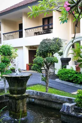 a fountain in front of a building at Legian Paradiso Hotel in Legian