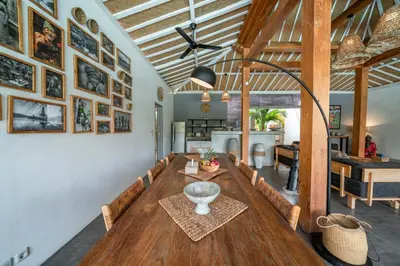 a dining room with a table and a living room at Villa Nahema - 4BR Villa in Seminyak Next to the Beach in Canggu