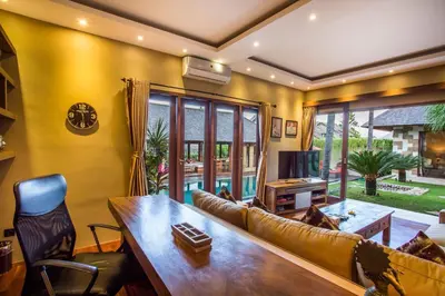 a living room with a couch and a table at Rachline Villa in Kerobokan