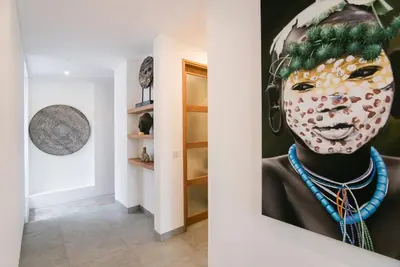 a painting of a clown on a wall in a hallway at Villa Kobe Beachside Berawa Canggu location in Canggu