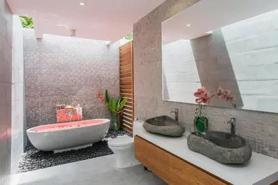 a bathroom with two sinks and a bath tub at Villa Kobe Beachside Berawa Canggu location in Canggu